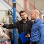 auto mechanic and customer at car shop